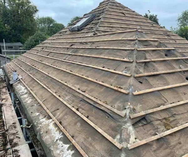This is a photo of a hip roof that has been stripped back to the battens, and is awaiting a new roof covering to be installed. Works carried out by TVB Roofing Wellingborough