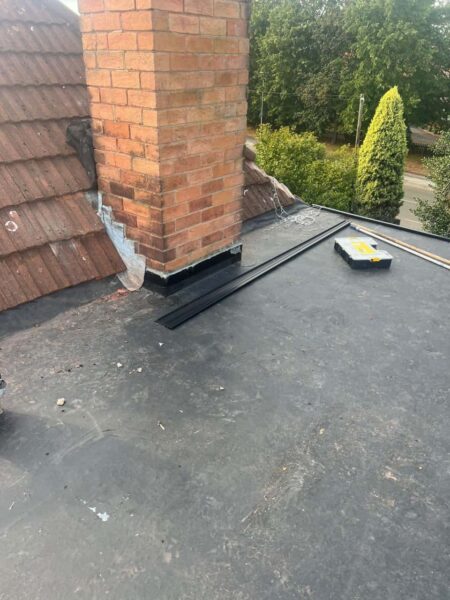 This is a photo of a flat roof which has just been repaired, there is also a chimney stack and some leadwork has also been dressed.